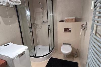 Kúpeľňa so sprchovacím kútom, práčkou a toaletou, ApartLiv, Veľká Lomnica